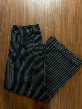 Voodoo Vixen black pinstripe trousers with a high-waisted fit and wide-leg